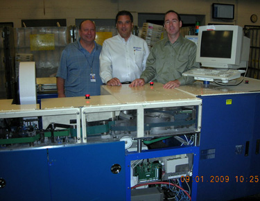 Figure 3: The USPS team standing next to one of the retrofitted machines.